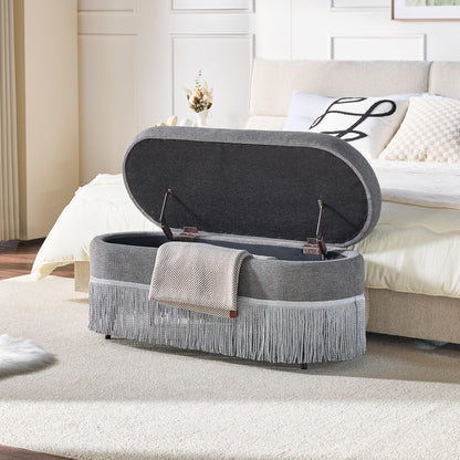 Oval Upholstered Storage Ottoman With Fringe Trim & Lift Top Lid